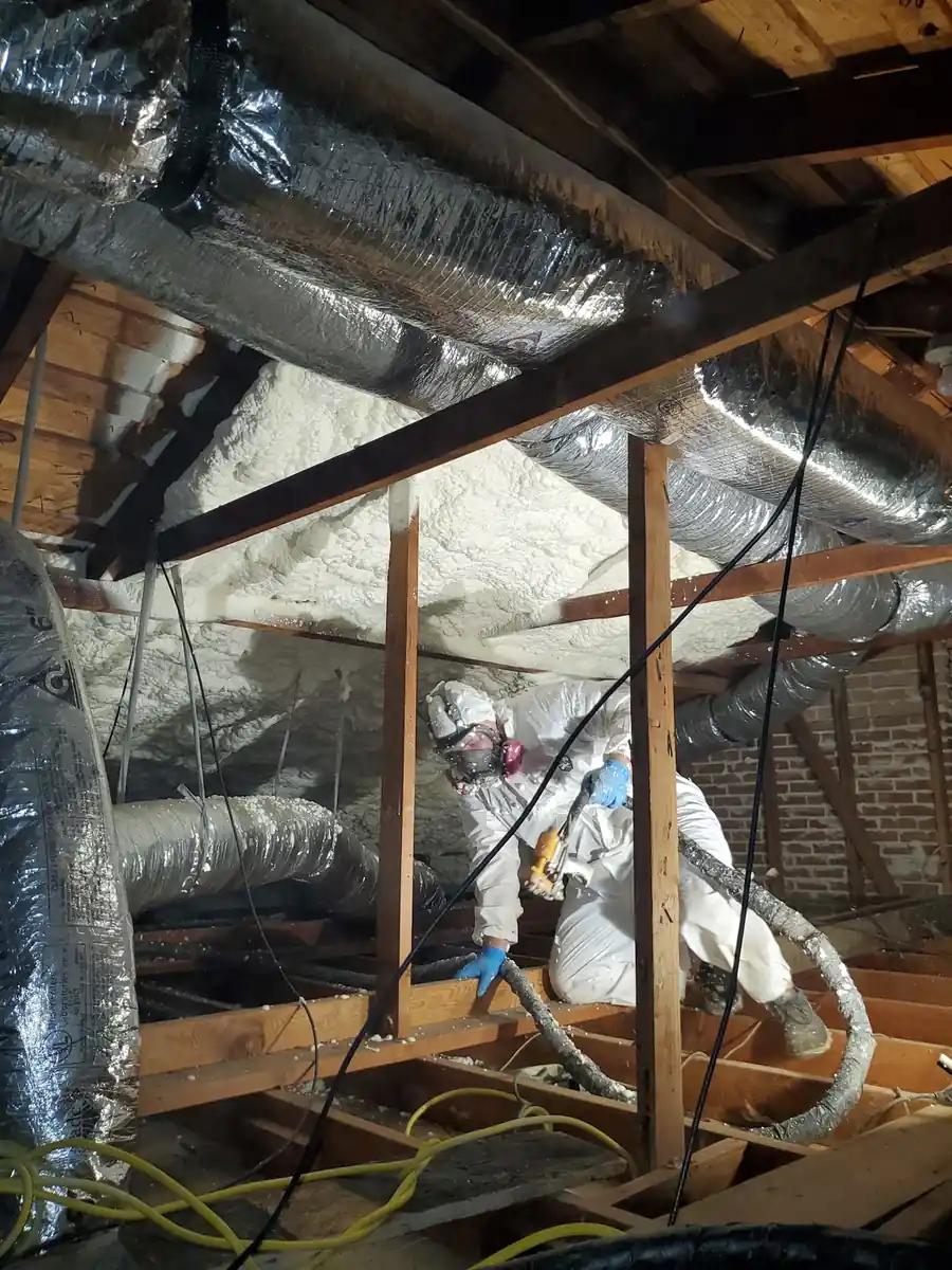 Technician spraying foam insulation in a Houston-area attic