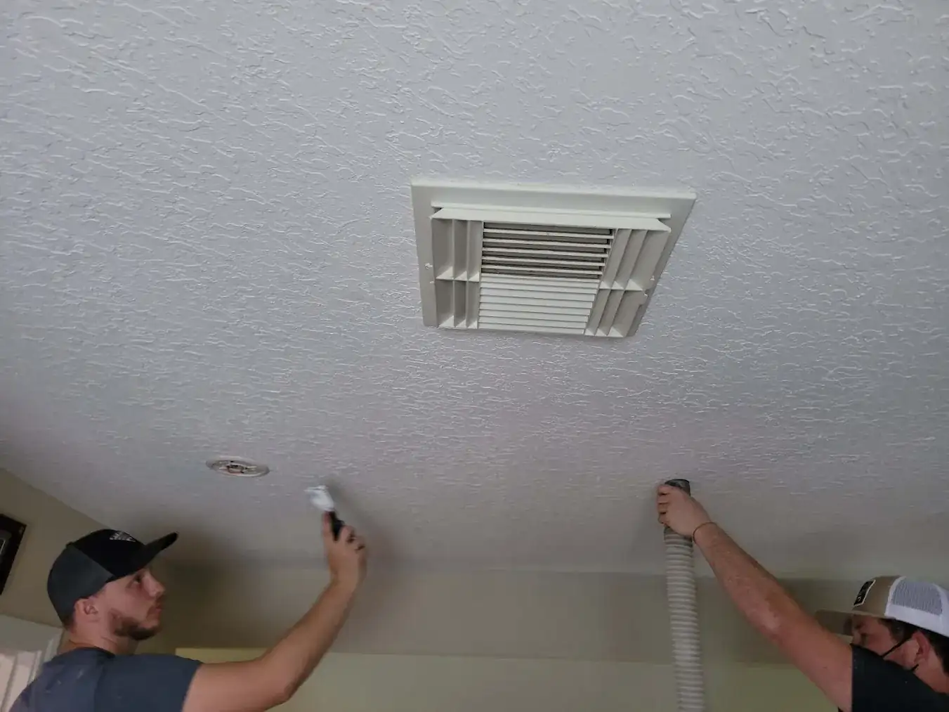 Insulation expert sealing attic bypasses on a Houston home