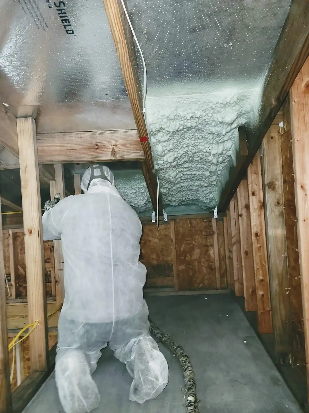 Closed-cell spray foam applied to an elevated subfloor and rim joist in Seabrook TX