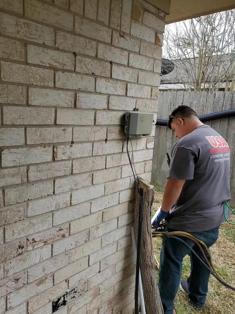 Crew injecting foam into wall cavities on a Houston home