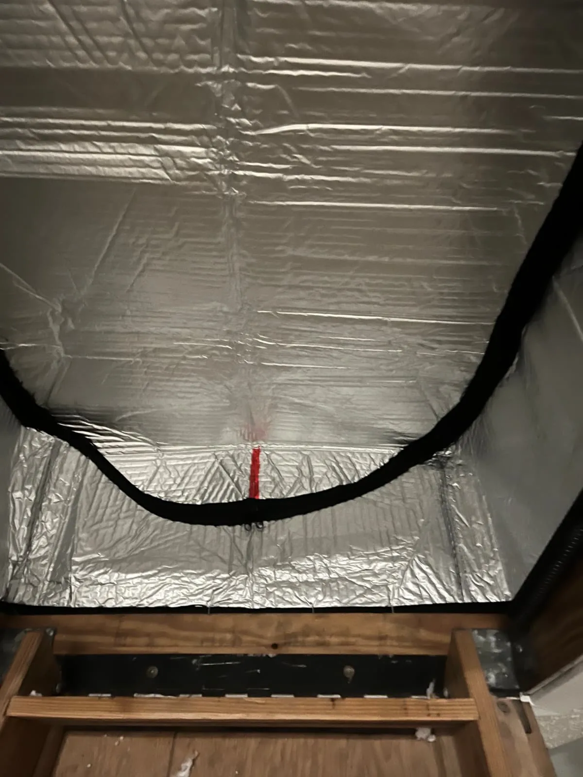 Sealed attic access hatch reducing air leaks in a Houston attic