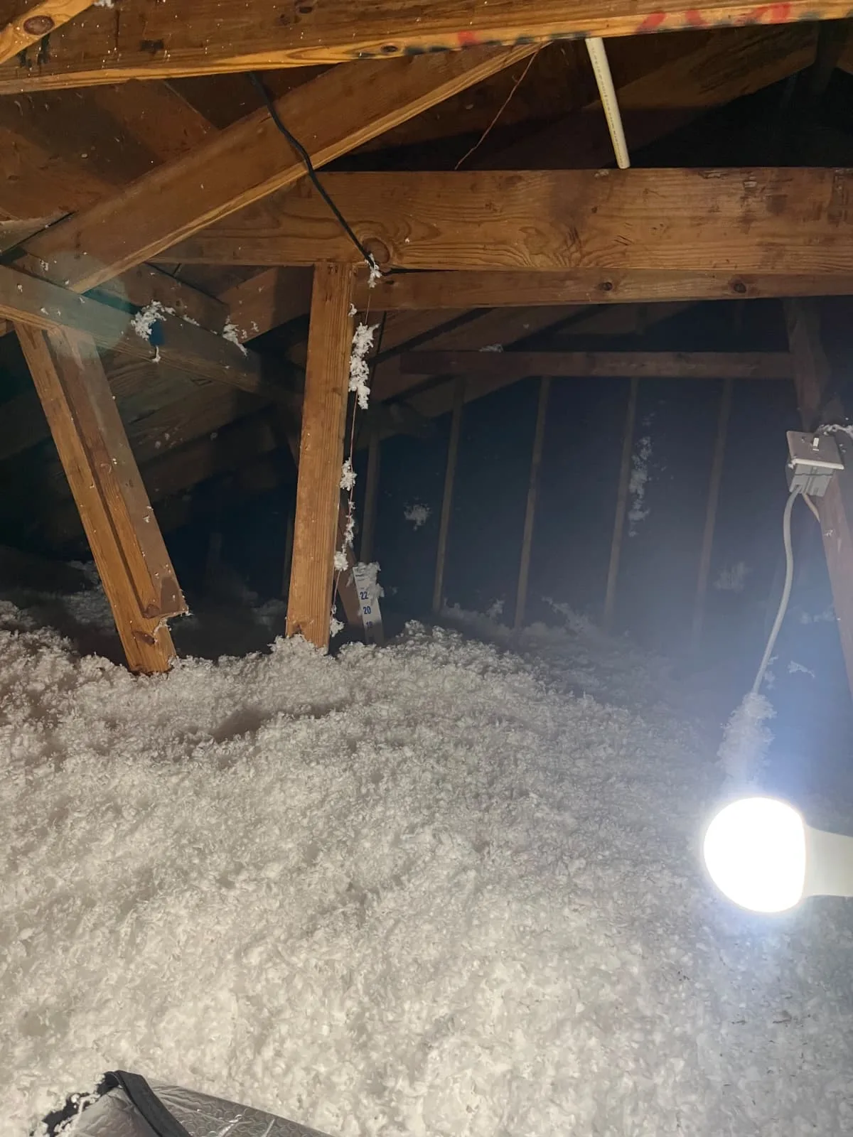 Blown-in attic insulation installed around HVAC ductwork in a Houston attic