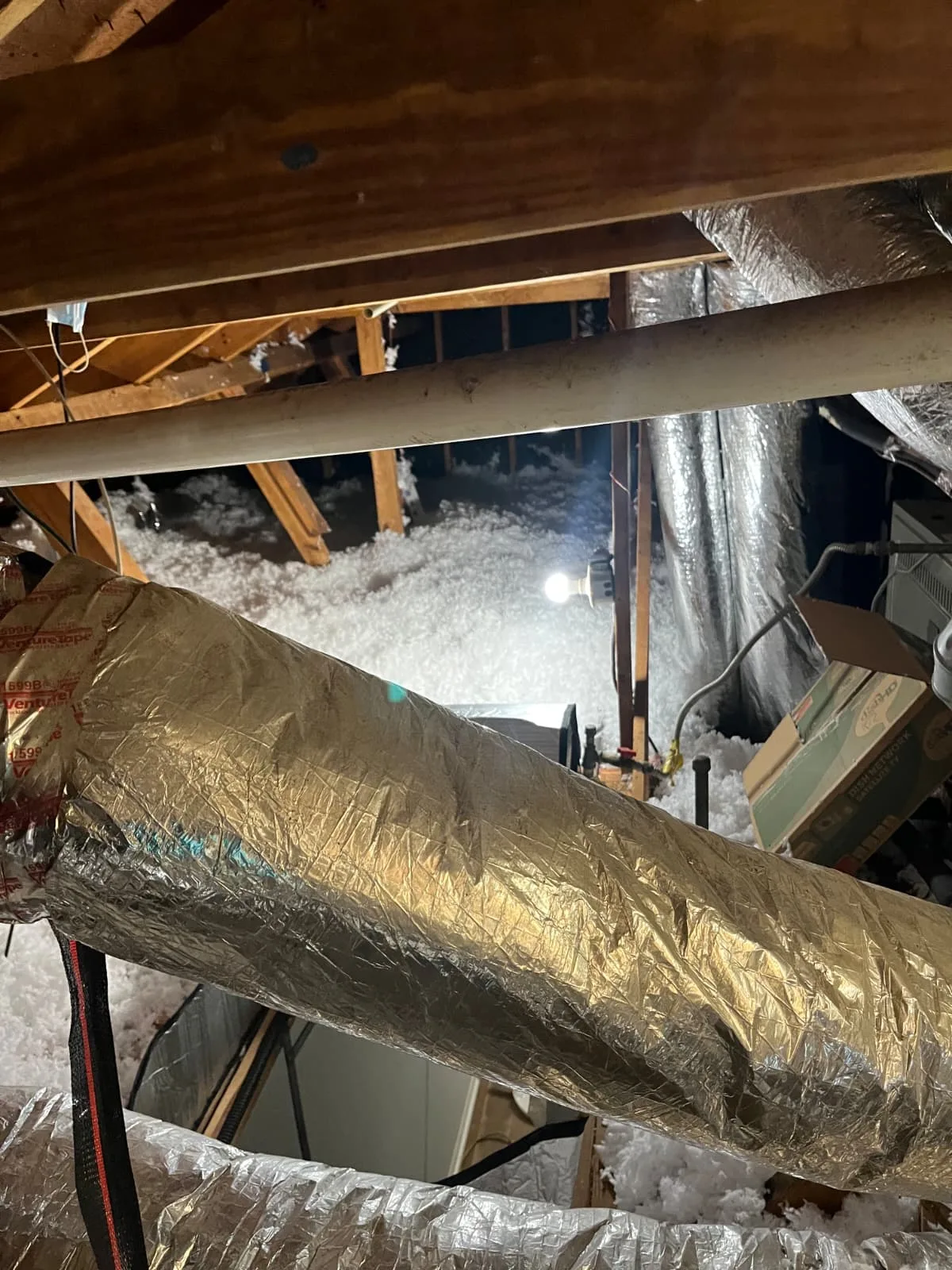Attic floor insulated to recommended depth around ductwork in a Houston home