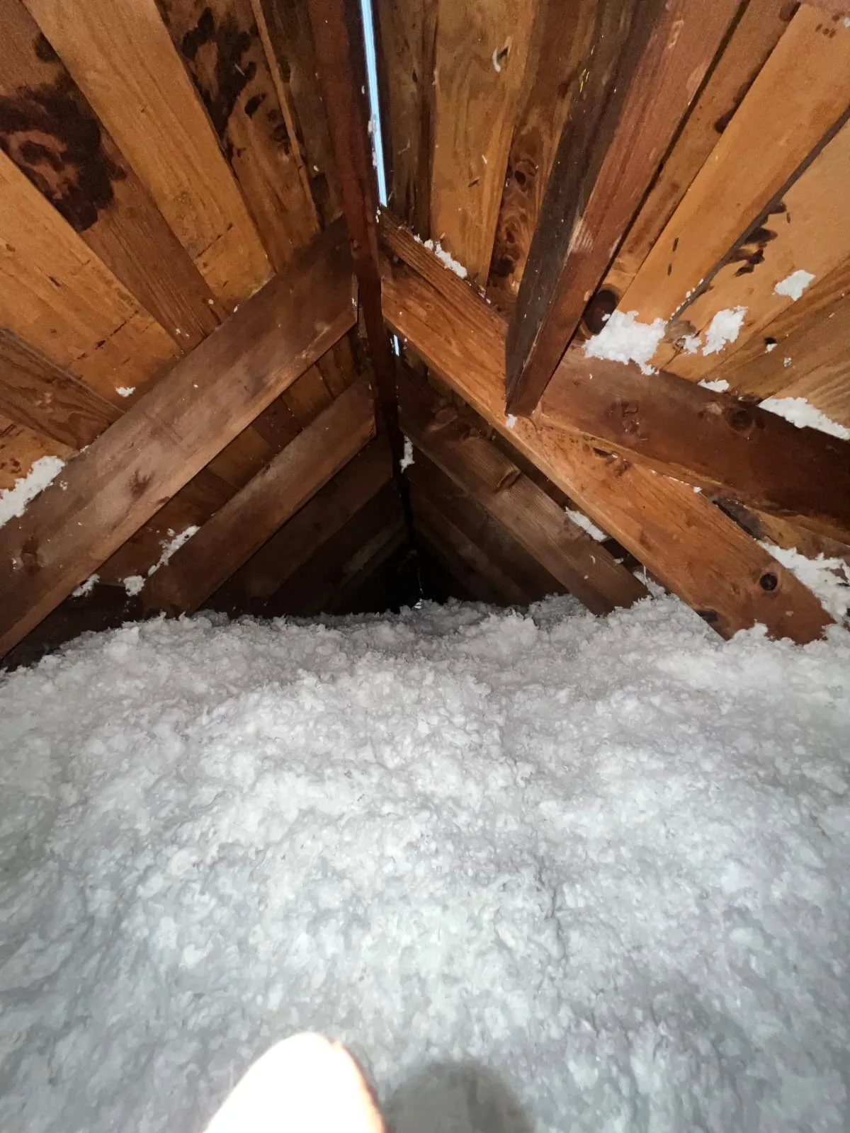 Blown-in insulation job near attic ductwork in Greater Houston