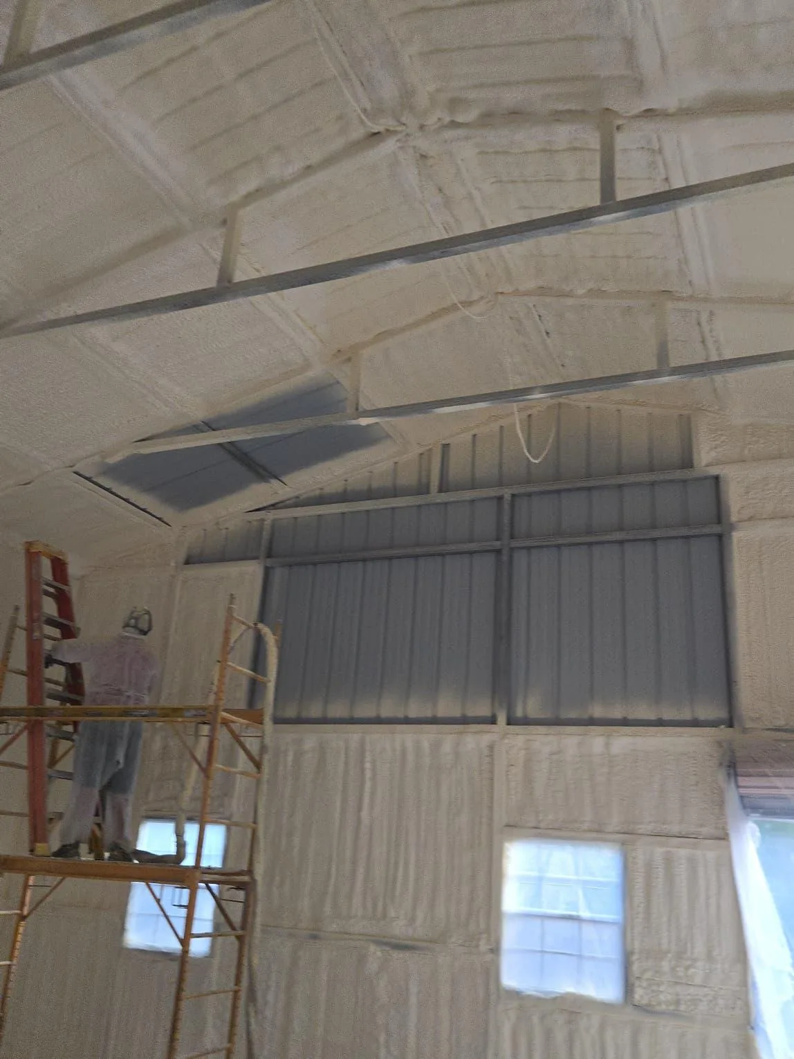 Spray foam coverage on interior metal building panels