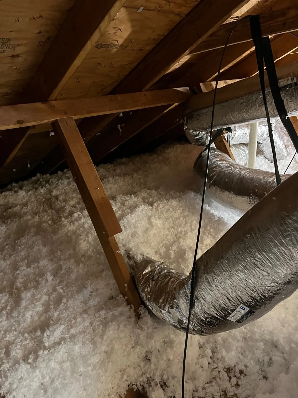Pasadena attic floor after blown-in fiberglass insulation