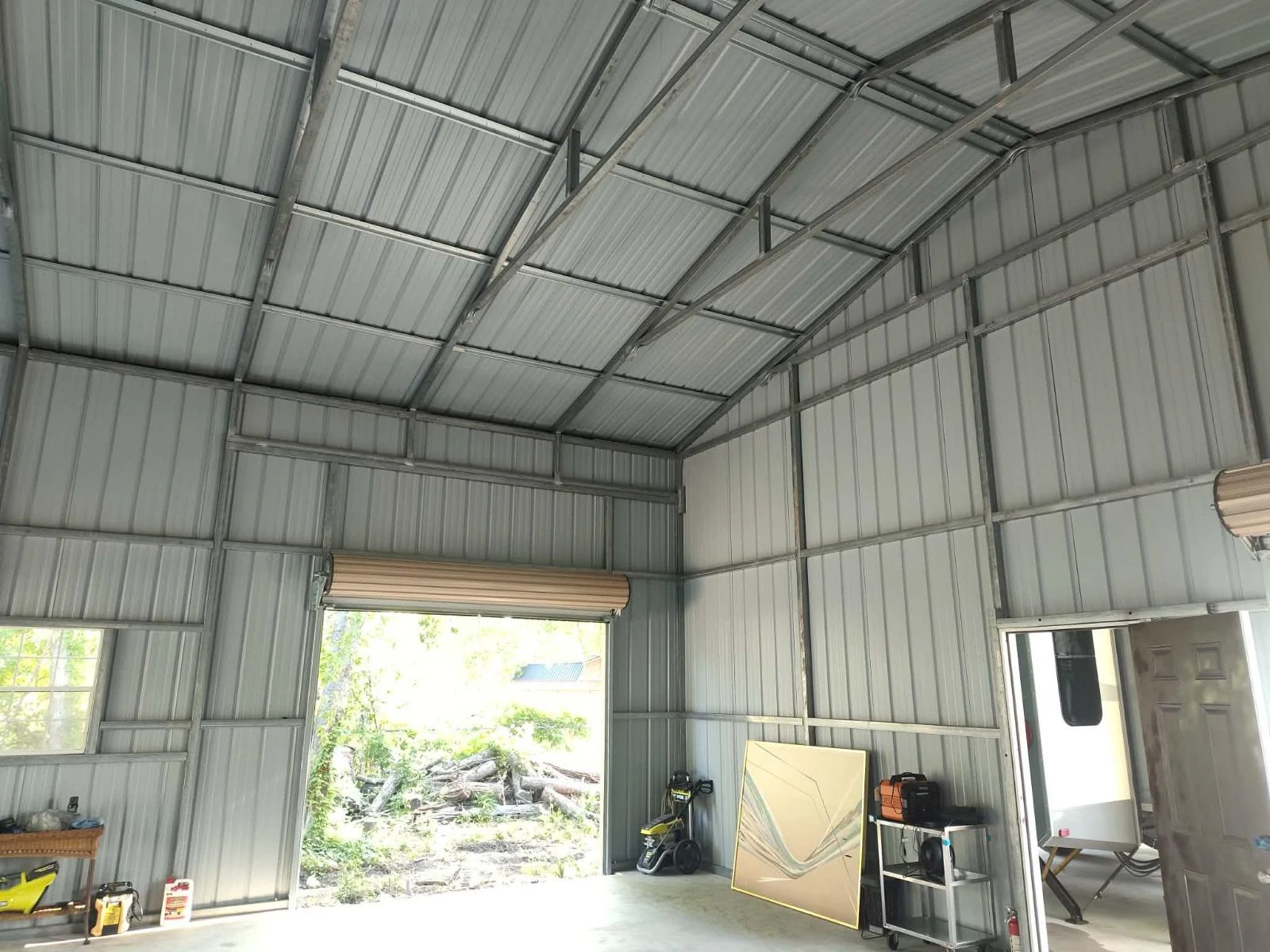 Pasadena metal building interior before spray foam, bare roof and walls
