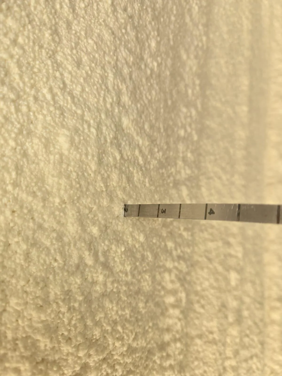 Verifying spray foam insulation meets target thickness in a Houston attic