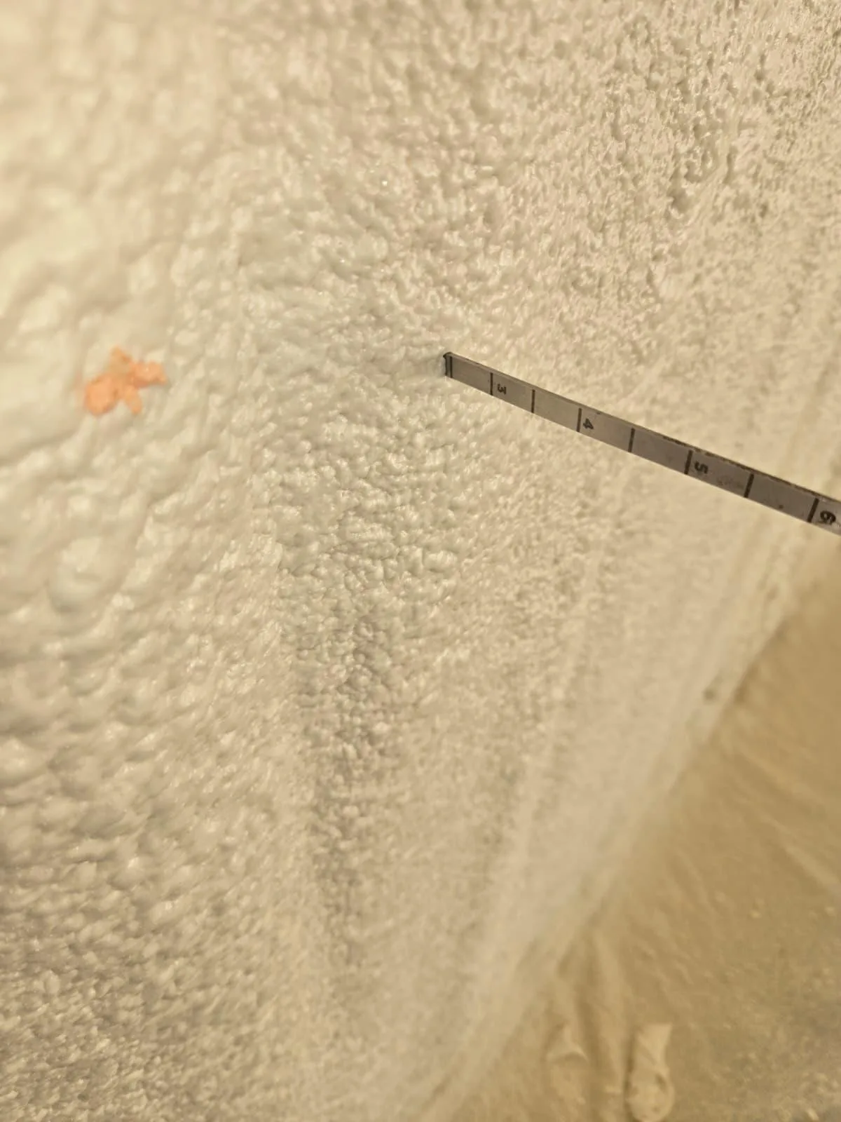 Confirming spray foam coverage depth in a Houston home attic